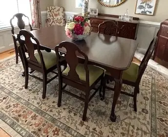 How to Protect a Dining Table While Entertaining Guests 3 Classic mahogany dining table and chairs refinished to a rich dark sheen, demonstrating proper dining table care and protection.