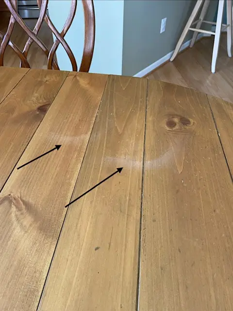 How to Protect a Dining Table While Entertaining Guests 1 Close-up of pine dining table with visible heat rings and surface marks, showing why dining table protection from heat is essential.
