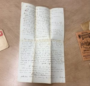 A carefully preserved handwritten letter from the late 19th century, written by a long-lost relative, found hidden inside the mid-19th century bureau desk.