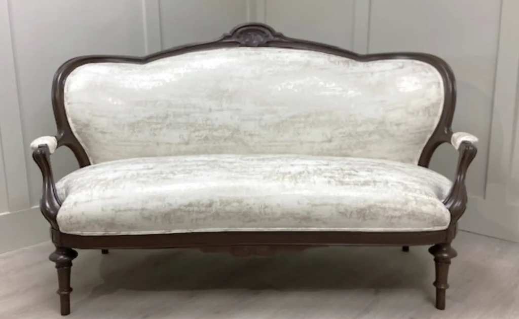 Victorian walnut settee reupholstered with eco-friendly fabric in Raleigh home