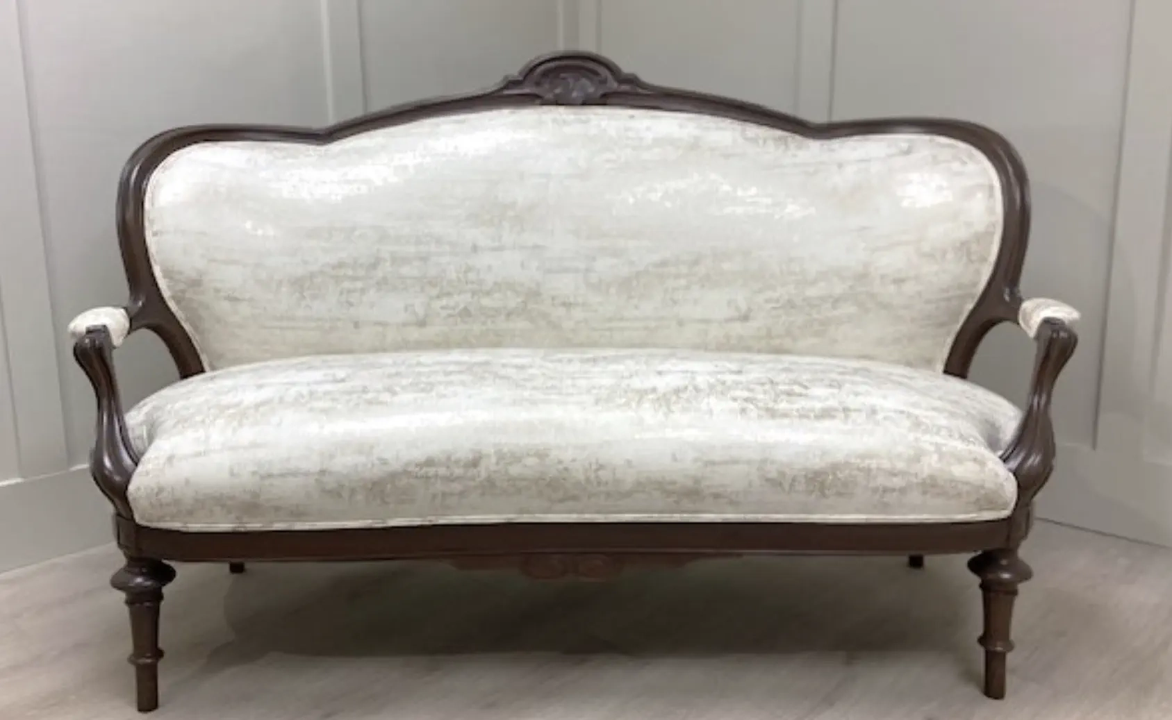 Victorian walnut settee reupholstered with eco-friendly fabric in Raleigh home