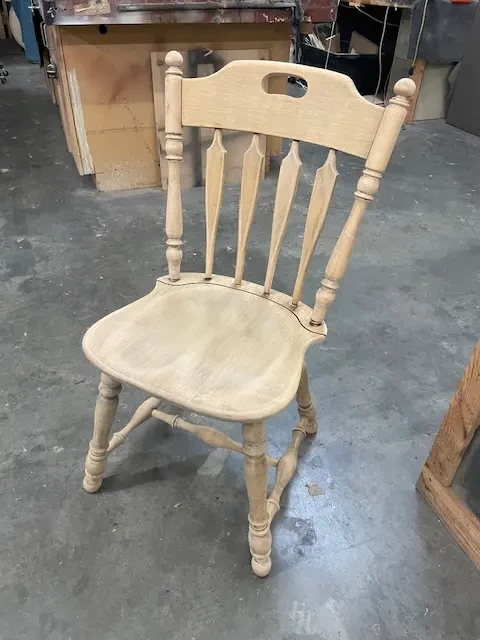 Kling maple dining chair after repair and sanding, showing clean, bare wood surface ready for stain application at Finish Pros workshop in Raleigh NC.