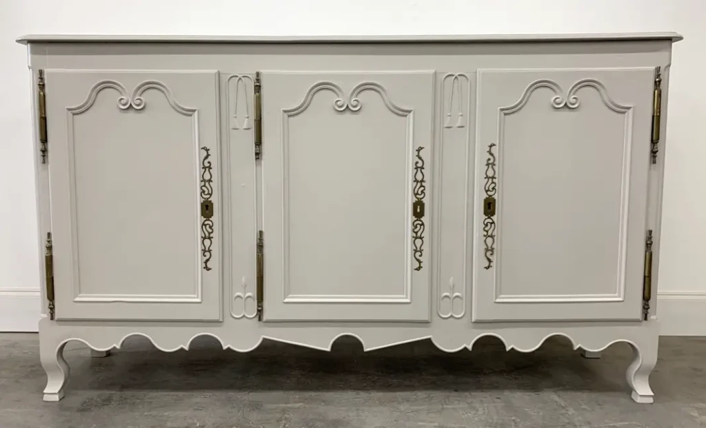 French-style buffet cabinet refinished in light gray painted lacquer with ornate brass hardware by Finish Pros in Raleigh NC.