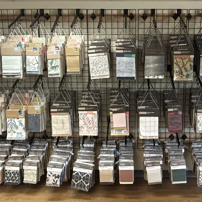 Upholstery fabric swatch books featuring top brands like Kravet, Fabricut, Charlotte Fabrics, and Trend Fabrics, available at Finish Pros in Raleigh, NC for reupholstery and custom furniture projects.