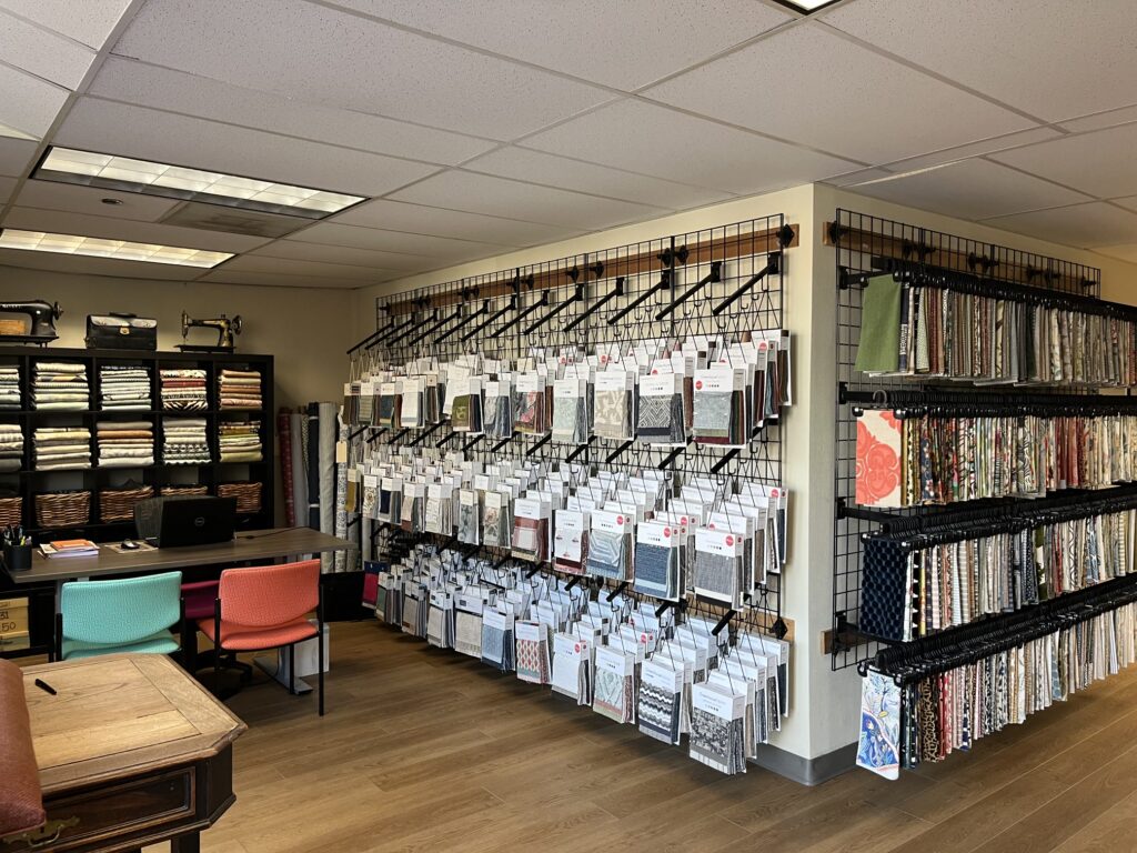 Protecting Upholstery Fabric: Tips from Raleigh’s Reupholstery Experts 2 Finish Pros fabric showroom in Raleigh, featuring a wide selection of upholstery materials and textile samples for custom furniture projects.