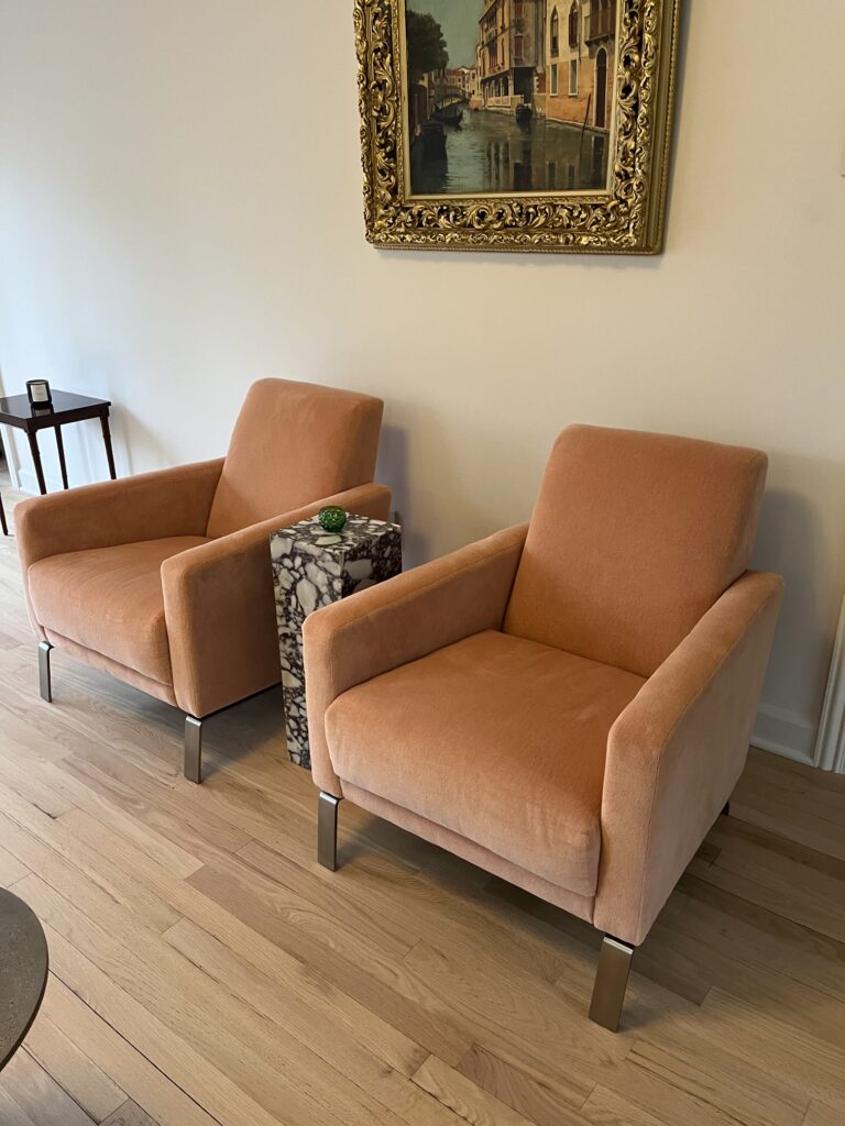 The Art of Reupholstery: How Finish Pros Transforms Raleigh Furniture with Craftsmanship and Care 6 A pair of sleek modern club chairs, fully reupholstered in performance velvet by Finish Pros, shown beautifully staged in the client’s Raleigh home after delivery.