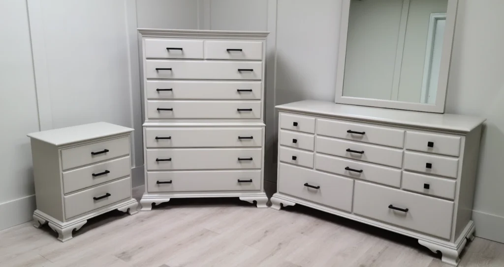 Will I ruin my furniture by painting? 2 This three-piece bedroom furniture set, consisting of a nightstand, tall chest, and dresser with mirror, was refinished by Finish Pros in a custom-mixed lacquer color matched to Sherwin Williams SW7015 Repose Gray. The pieces feature a soft satin finish and were completed with sleek modern black hardware, offering a sophisticated and cohesive look.