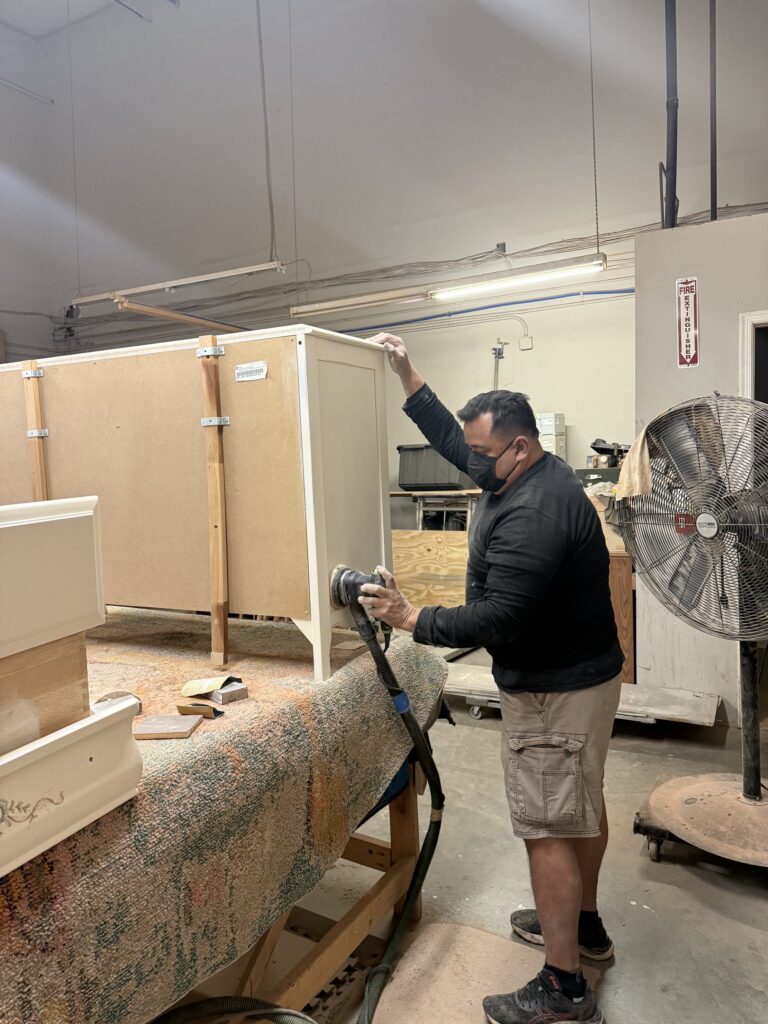 2026 Furniture Color Trends: How to Refresh Your Home with Expert Refinishing & Upholstery 6 Our craftsman hand-sands a client’s dresser with precision and care, preparing the surface for a flawless lacquer finish. At Finish Pros, every piece is treated with the respect and attention it deserves, ensuring a beautiful and lasting result.