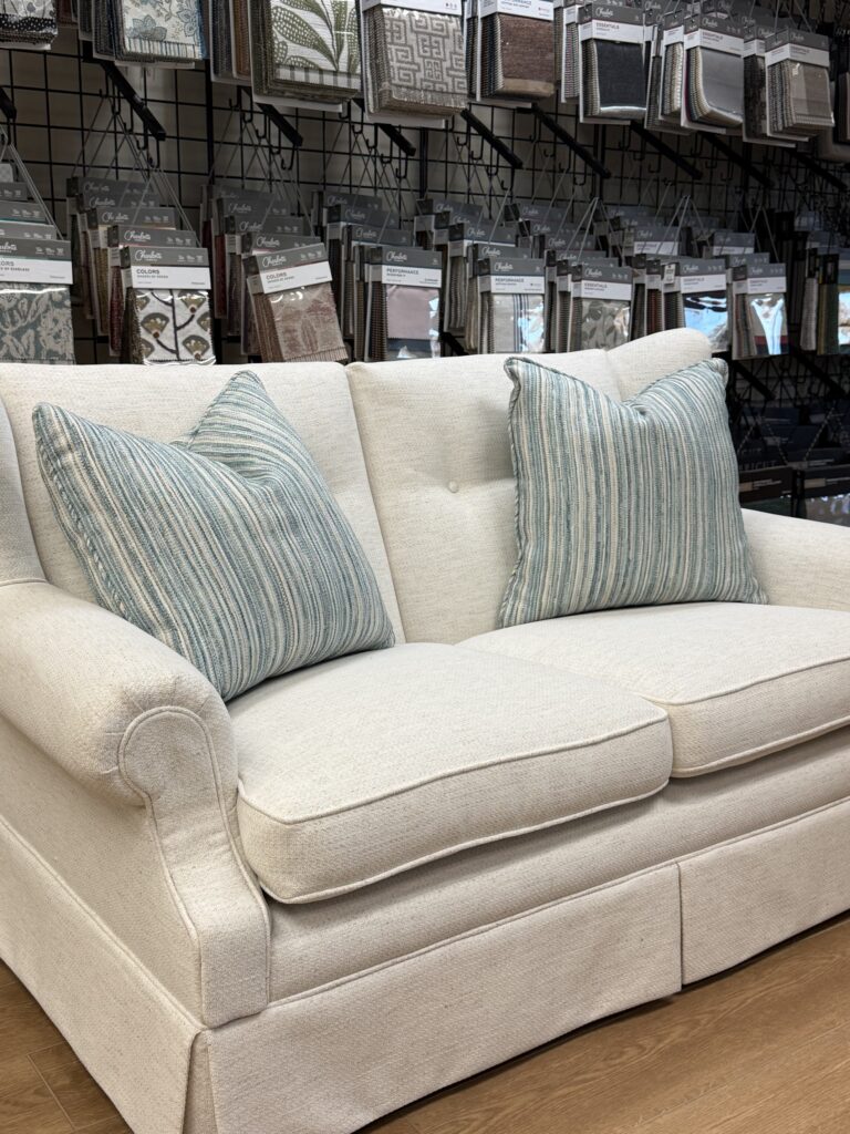 2026 Furniture Color Trends: How to Refresh Your Home with Expert Refinishing & Upholstery 8 After: Loveseat reupholstered in Greenhouse Ice F1415, a warm ivory performance fabric, offering a fresh, neutral foundation ideal for layering pops of color throughout the room.