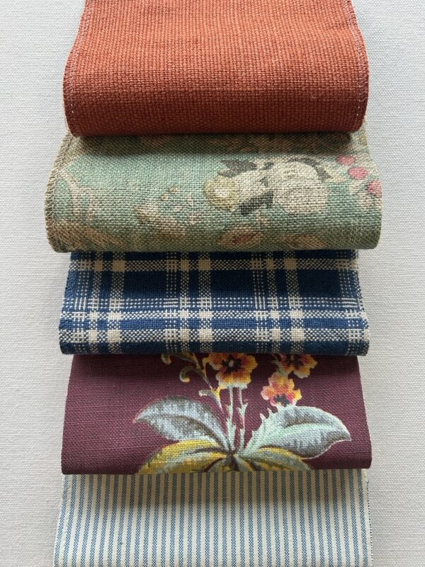 What Happens During a Finish Pros Design Consultation? 3 Designer upholstery fabric samples in multiple patterns and textures at Finish Pros Raleigh NC used for custom upholstery, furniture reupholstery, and interior design projects